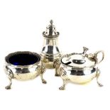 An Elizabeth II silver three piece cruet set, each with a gadrooned border, comprising mustard