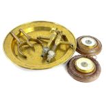 A collection of items, to include a brass charger, two circular aneroid barometers, a pair of hot
