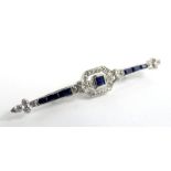 An Art Deco sapphire & diamond bar brooch, set with central square cut blue sapphire 3mm x 3mm,