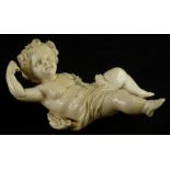 A 19thC carved ivory putto, the head carved with flowers and leaves, lacking wings, etc., 16cm