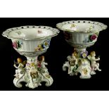 A pair of Schierholz porcelain centrepieces, each with flower encrusted decoration and with a