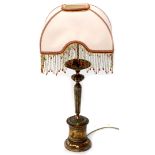 A copper lamp base with fluted and beaded decoration, with a silk shade with beaded tassels, 72cm