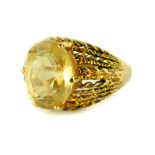 A 9ct gold dress ring, set with oval cut citrine stone, in six claw setting, with pleated design
