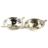 A pair of Edwardian silver two handled wine tasters, each a faceted form, Birmingham 1909, 2½oz.