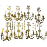 An associated set of eight Louis XVI style gilt metal two branch wall lights, each decorated with