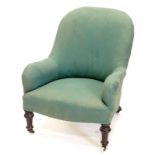A Victorian mahogany armchair, upholstered in green fabric on turned tapering legs, with ceramic