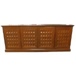 An oriental hifi cabinet, the top with three hinged sections, above four lattice panelled doors,