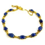 A 9ct gold polished sapphire necklace, of graduated design necklace set with various oblong uncut