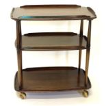 An Ercol elm and beech three tier galleried trolley, on large castors, 77cm high, 69cm wide.