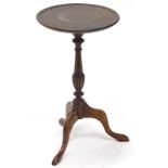A mahogany wine table, the circular dish top on a turned and fluted column, tripod base, the top