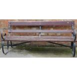 A slatted garden bench, with ebonised wrought iron ends, 173cm wide.