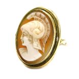 A 19thC shell cameo dress ring, the oval shell cameo with figure of a warrior in headdress, in a rub