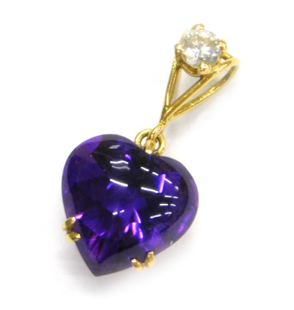 An amethyst and diamond heart shaped pendant, the heart shaped cabochon amethyst 10.5mm x 9.5mm,