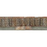 A collection of nine Victorian wrought iron rectangular panels, each decorated with a central