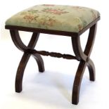 A mahogany stool in Regency style, with a padded top, reeded edge, on X shaped end supports with