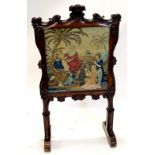 An early Victorian rosewood fire screen, rectangular cartouche shaped frame, carved with a fleur-