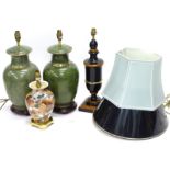 A pair of ceramic green based lamp bases, a composite ebonised and simulated wood lamp base, and