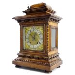 A late 19th/early 20thC German walnut mantel clock, the case decorated with beading reel, applied