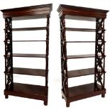 A pair of hardwood open stands or bookcases, each with a moulded cornice on turned supports with X