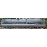 A cast iron agricultural feeding trough, of bowed shape, 152cm wide.
