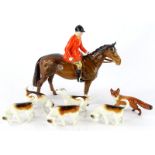 A Beswick model of a huntsman riding a brown horse, five hounds and a small fox (7).