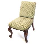 An unusual Victorian rosewood nursing chair, with a padded back and seat on cabriole legs.