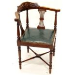 An Edwardian carved mahogany corner chair, with carved mahogany seat on turned tapering legs.