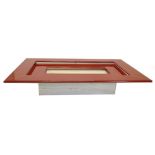 A Paulo Piva red lacquer and chrome plated coffee table, on a variegated marble rectangular base,