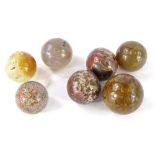 Seven 19thC ceramic and semi precious stone marbles. Provenance: The Estate of Miss Rachel Monson.