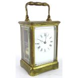 A late 19th/early 20thC French brass carriage clock, the enamel dial with Roman numerals (AF),