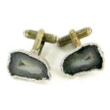 A pair of silver geode set cuff links, with bark effect surround, in partial box.