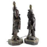 A pair of late 19th/early 20thC oriental carved hardwood lamp bases, each decorated in the form of