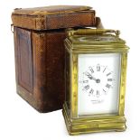 A late 19thC French brass carriage clock, the corniche shaped case with bevelled glass, the enamel
