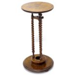 A Victorian walnut occasional table, the circular top on spirally turned supports, with platform,