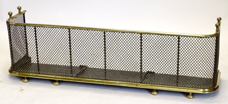 A late 19th/early 20thC brass and mesh fender or fire curb, on bun feet, 117cm long.