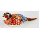 A Royal Crown Derby porcelain pheasant paperweight, silver button to underside.