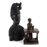 Tribal Art. An unusual carving of a figure seated and using a sewing machine, 24cm high and a finely