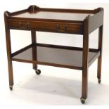 A walnut galleried trolley, with a frieze drawer above an under tier on castors, 76cm wide.