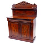 A Victorian mahogany chiffonier, the raised back decorated with shells, leaves, etc., with a