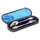 A Victorian silver christening set, comprising spoon and fork, each with a rococo scroll handle
