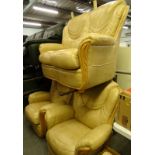 A three piece suite, comprising two seat cream leather sofa, and two chairs.