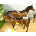 A Beswick horse, brown colourway, white face, standing, printed marks beneath, 20cm high and another