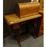 A Singer treadle sewing machine, in oak case.