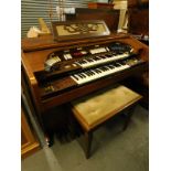 A Farfisa teak framed church style electric organ with two banks of keys, lower manual and other