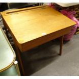 A mid to late 20thC child's desk, with a hinged lid enclosing a vacant interior, on shaped legs,
