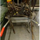 A large quantity of leather horse tack, and a wheel barrow.