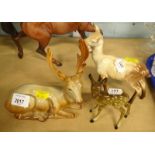 A Beswick recumbent stag, number 954, 18cm wide, a standing doe and a further fawn, unmarked (3).