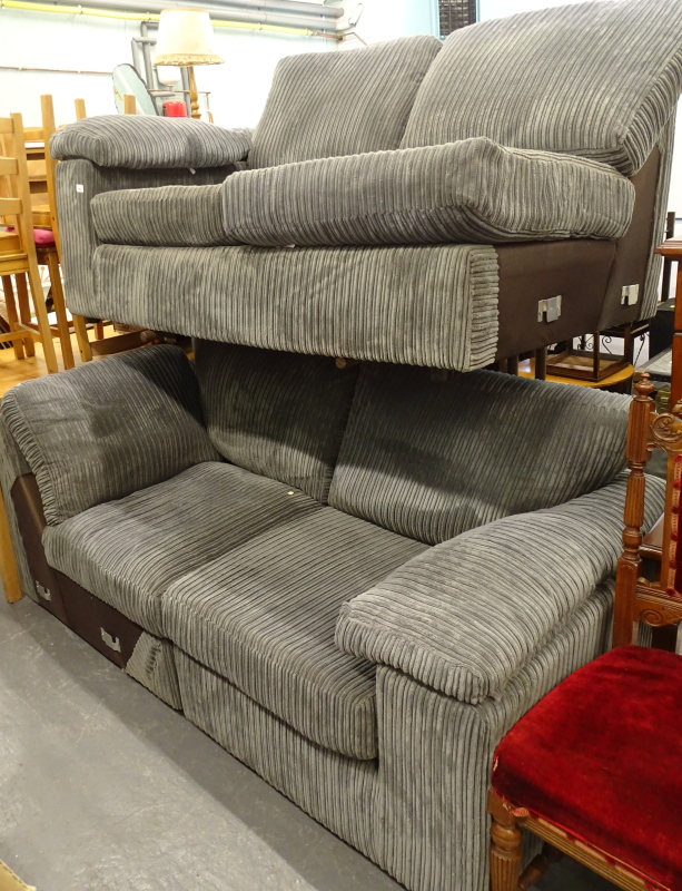 A four seat corner sofa, upholstered in grey cord.