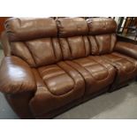 A leather reclining three seat sofa.