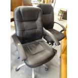 Two modern black swivel office chairs.